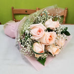 This is made by a flower shop in UBC village, Vancouver. Light pink, Peach roses champaign roses, white haze grass and some green, eucalyptus are in bouquet with pink special rapping. For wedding, birthday, any special events.